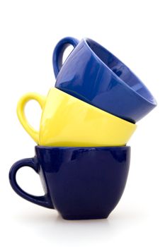 Three multi colored tea cups on a white background