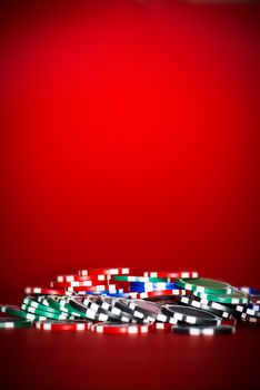 chips for poker on red table with place for text