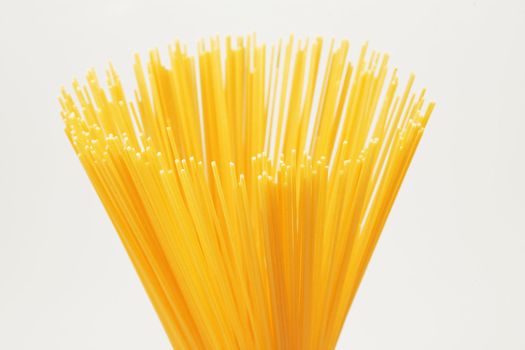 Bunch brightly yellow a spaghetti on a white background