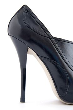 Female leather shoe with a high heel on a white background