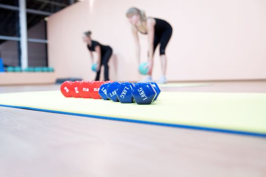 Red and blue dumbbells in a modern hall for sports trainings