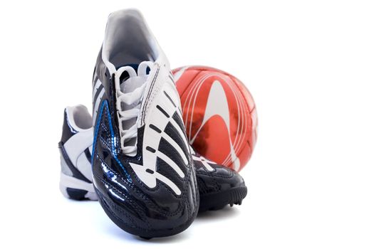 Sports footwear and red soccer ball on a white background