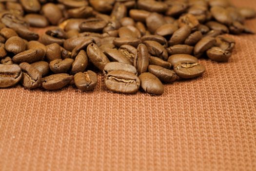 scented coffee beans scattered on a brown braided material
