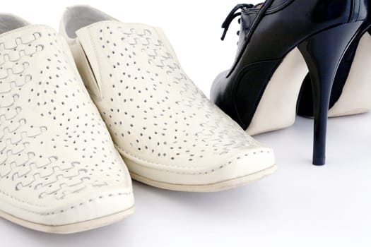 Man's and woman's leather shoes on a white background