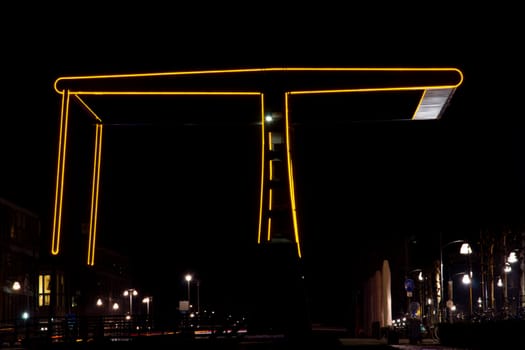 Lighted silhouette of a bridge at night