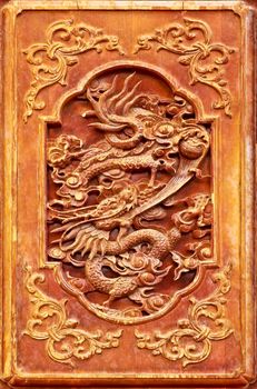 Dragon design on the wooden door of Chinese temple