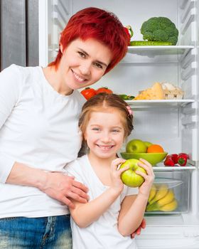 Mother and daughter with apple