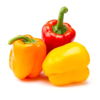 Red, orange and yellow paprika peppers against a white background