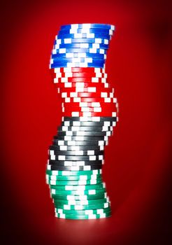 stack of chips on red poker table