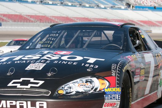 LAS VEGAS NEVADA - FEB. 11: Unknown driver and smiling female customer at the Richard Petty NASCAR driving school experience at the Las Vegas Motor Speedway on February 11, 2012 in Las Vegas Nevada.