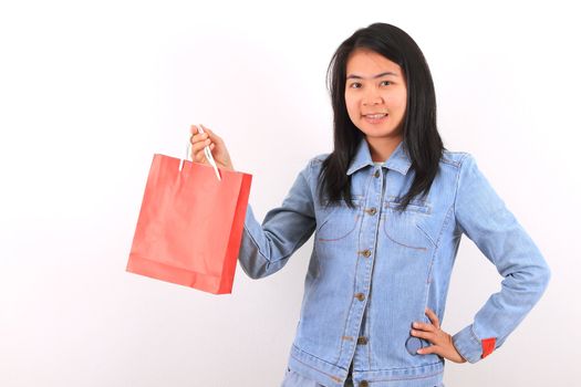 Happy shopping woman show her bags and smiling isolated over white