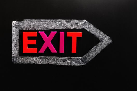 Exit - word made of colorful letters on a blackboard