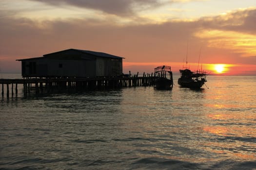 Silhouette of wooden jetty at sunrise, Koh Rong island, Cambodia, Southeast Asia