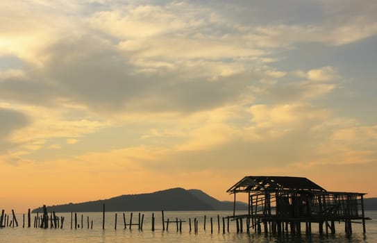Silhouette of old wooden jetty at sunrise, Koh Rong island, Cambodia, Southeast Asia