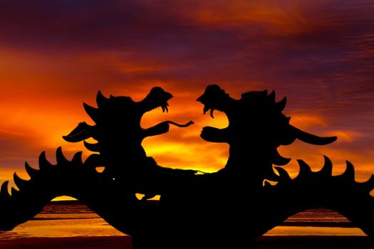 Silhouettes of dragons against a red sunset
