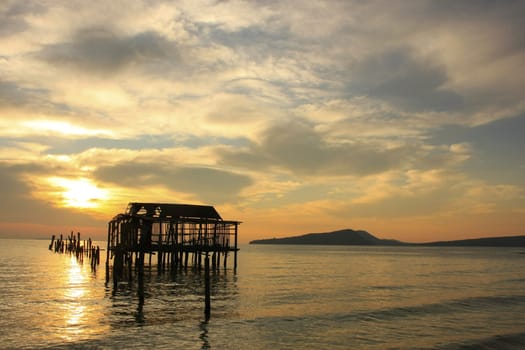 Silhouette of old wooden jetty at sunrise, Koh Rong island, Cambodia, Southeast Asia