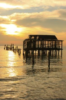 Silhouette of old wooden jetty at sunrise, Koh Rong island, Cambodia, Southeast Asia