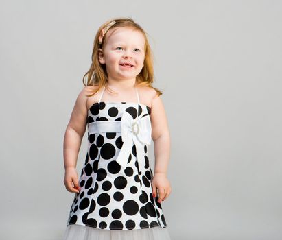 little girl in studio in gray background