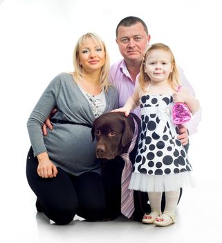 Happy family with black dog in studio isolated on white