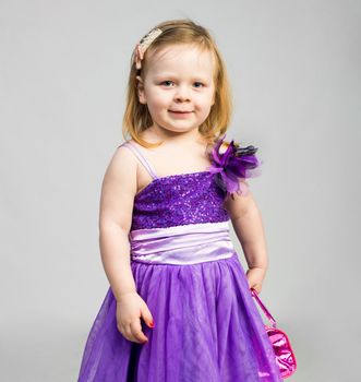 little girl in studio in beautiful dress