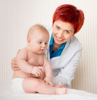 Smiling doctor with adorable baby girl