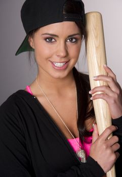 Attractive Woman in Baseball Cap holds her gear