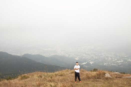 Asian man hiking in mountains