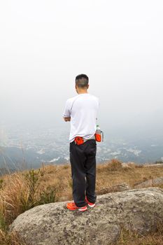 Asian man hiking in mountains