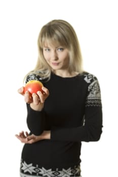 beautiful girl with long blond hair offers apple