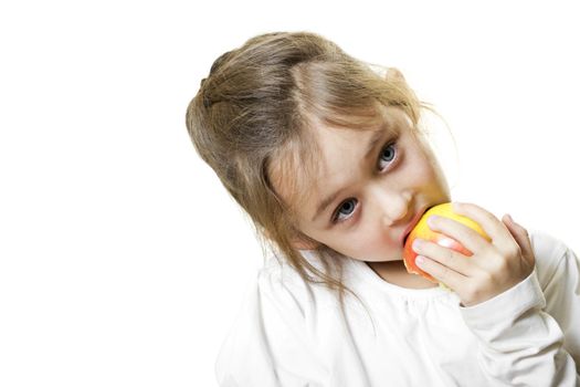 little girl with blue eyes eating an apple