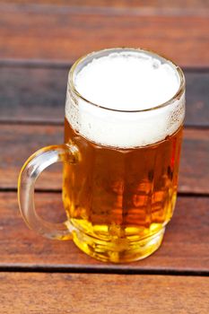 mug with light  beer standing on the table