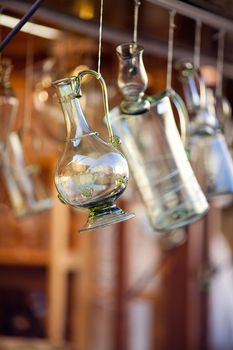 decanters of bohemian glass hanging on hooks