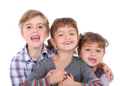 Studio portrait of three young siblings