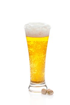 light beer with the foam in a tall glass and pistachios isolated on white