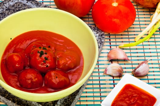 Bowl with meatballs and tomato sauce