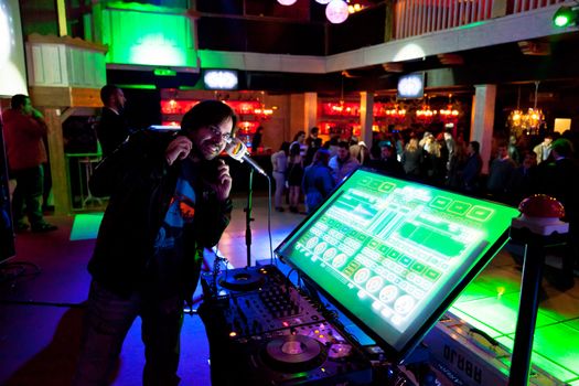 CHICLANA, SPAIN - JAN 27: DJ Alvaro Reina next to the mixer to begin the party of the hot mix energy danceflor of the Los 40 Principales  on Jan 27, 2012 in Chiclana, Spain
