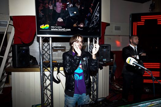 CHICLANA, SPAIN - JAN 27: DJ Alvaro Reina next to the mixer to begin the party of the hot mix energy danceflor of the Los 40 Principales  on Jan 27, 2012 in Chiclana, Spain