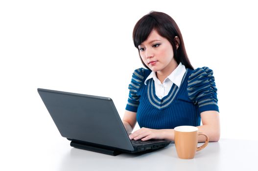 Portrait of an attractive Asian girl using laptop over white background.