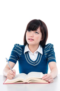 Portrait of an attractive Asian female student looking upwards against white background.