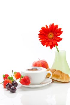 cappuccino in a cup in the shape of hearts,gerbera,apple,cherry,croissant and strawberries isolated on white