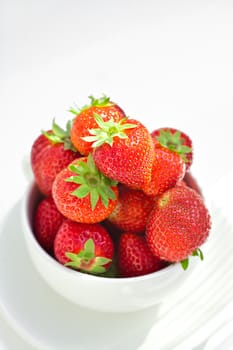 strawberries in a bowl in the daylight