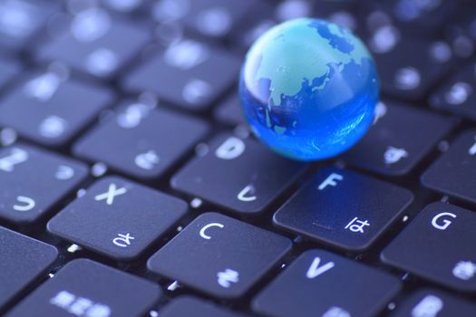 close up a Glass globe over the keyboard