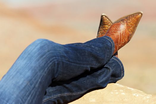 Western style image of cowgirl's legs in jeans and boots