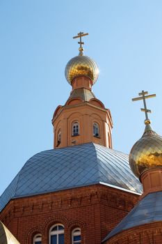 Golden domes of Christian church against the blue sky