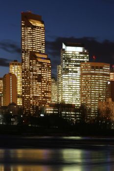 Office buildings at night by the river