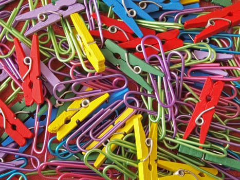 Close-up of multicoloured paper clips and pegs.