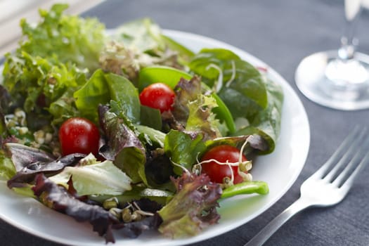 Close up image of healthy salad with table setting