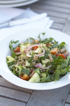 Healthy salad on outdoor table, couscous, shallow depth of field