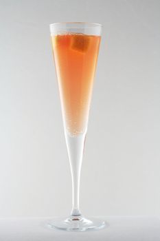 champagne and mango cocktail in tall stem glass, part of a series of 3 shots