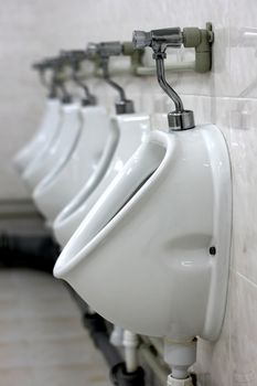 Row of urinals in a public toilet